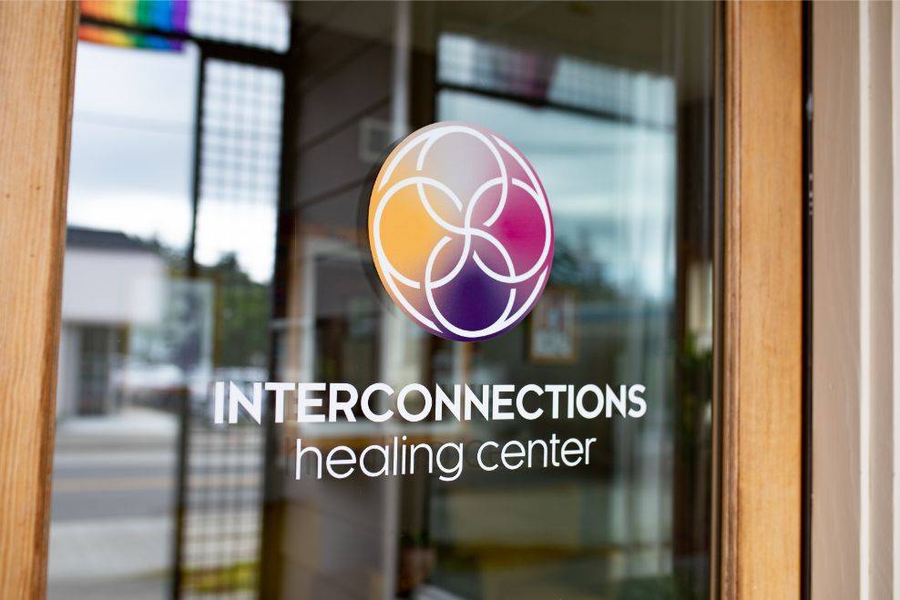 Main Image: Decal of logo with interconnecting circles on a door window